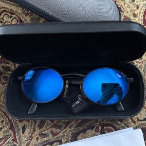 Vintage REVO Sunglasses with Black Frame and Vibrant Mirror Blue Lenses